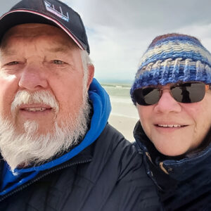 mark dougherty smiling with his wife while visiting the beach