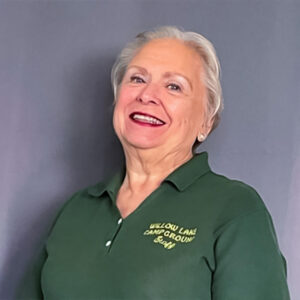 mary ann weema smilling and wearing green staff polo