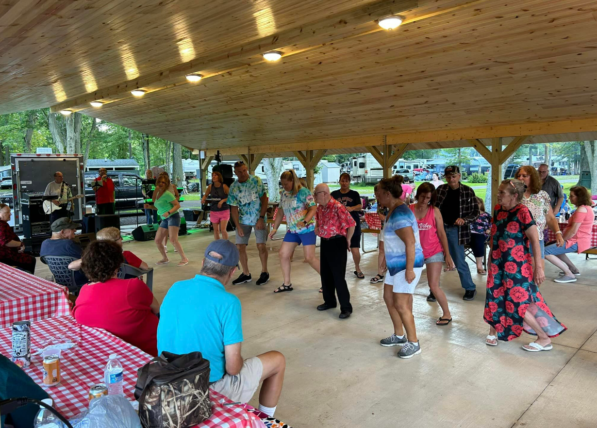 willow lake campground visitors attending a potluck and line dancing under a pavilion
